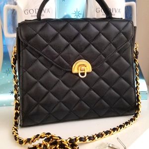 Leather top handle very structured timeless handbag with gold hardwares.